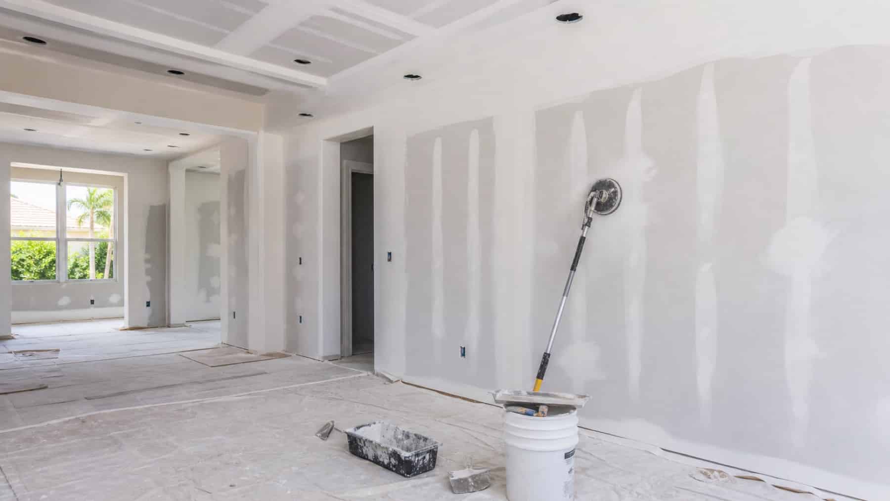 Drywall finish levels in a Bonita Springs remodel with smooth taped seams and protected floors